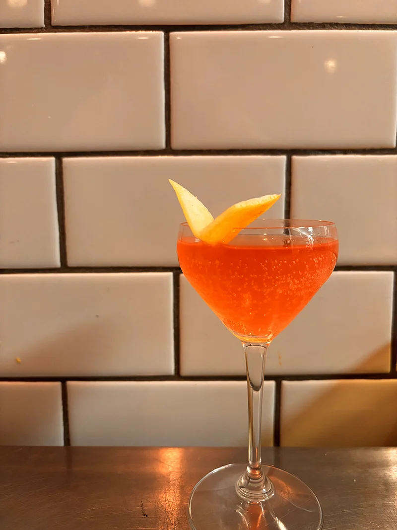 Jazmín cocktail, gin, Campari, lemon, and sparkling rosé